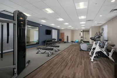 a gym with treadmills and exercise equipment in a room at Homewood Suites By Hilton Cincinnati Midtown in Cincinnati