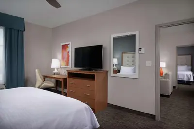 a hotel room with a bed and a flat screen tv at Homewood Suites By Hilton Cincinnati Midtown in Cincinnati
