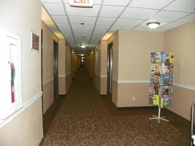 a hallway in a hospital building with a hallway at Royalton Inn & Suites Upper Sandusky in Upper Sandusky