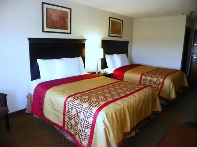 a hotel room with two beds in a room at Royalton Inn & Suites Upper Sandusky in Upper Sandusky