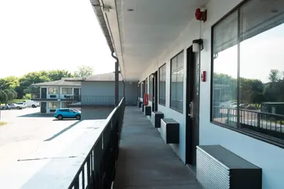 an empty hallway of a school building with a blue car at Anderson Inn, Anderson, Indiana in Anderson
