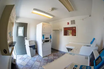 a kitchen with a white refrigerator and a counter at Anderson Inn, Anderson, Indiana in Anderson