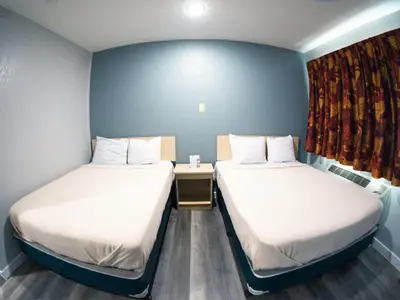 a room with two beds and a window at Anderson Inn, Anderson, Indiana in Anderson