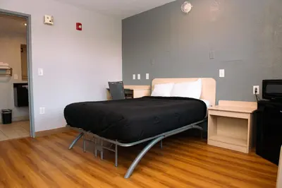 a hospital bed in a room with a television at Anderson Inn, Anderson, Indiana in Anderson
