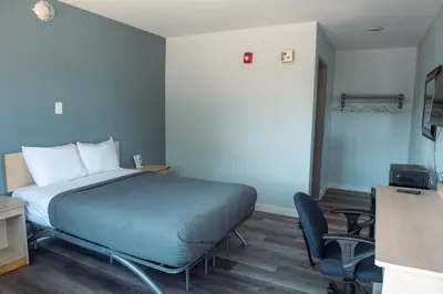 a bedroom with a bed and a desk and a chair at Anderson Inn, Anderson, Indiana in Anderson