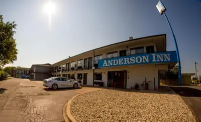 a building with a car parked in front of it at Anderson Inn, Anderson, Indiana in Anderson