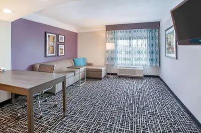 a living room with a couch and a table at La Quinta by Wyndham Cincinnati Airport Florence in Florence