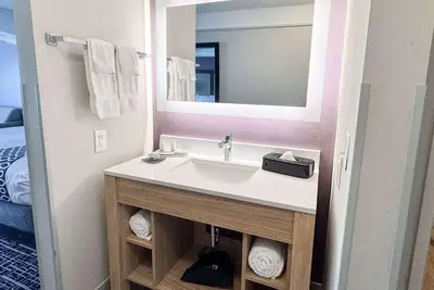 a bathroom with a sink and a mirror at La Quinta by Wyndham Cincinnati Airport Florence in Florence