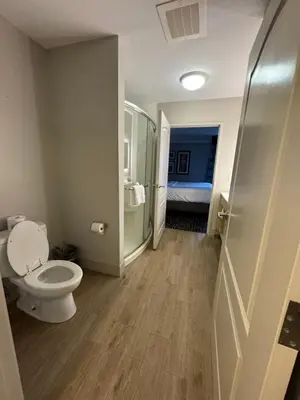 a bathroom with a toilet and a shower and a bed at La Quinta by Wyndham Cincinnati Airport Florence in Florence