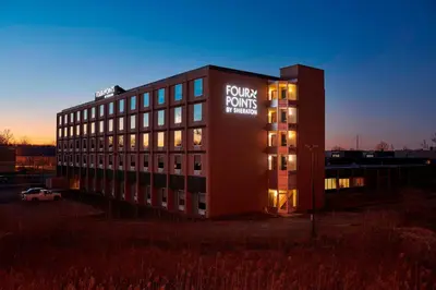 a building with a sign on the side of it at Four Points by Sheraton Cleveland-Eastlake in Eastlake