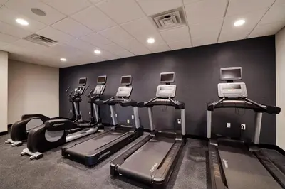 a gym with a row of treadms and machines at Four Points by Sheraton Cleveland-Eastlake in Eastlake