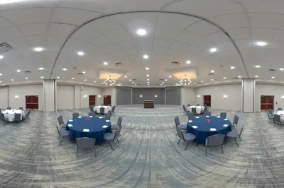 a large banquet hall with blue tables and chairs at Four Points by Sheraton Cleveland-Eastlake in Eastlake