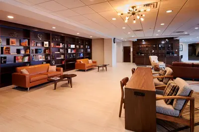 a waiting room with couches and chairs in a library at Four Points by Sheraton Cleveland-Eastlake in Eastlake