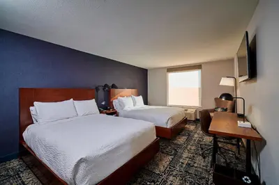 a hotel room with two beds and a desk at Four Points by Sheraton Cleveland-Eastlake in Eastlake