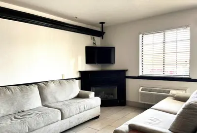a living room with a couch and a fireplace at Super 8 by Wyndham Madison IN in Madison