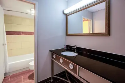 a bathroom with a sink and a mirror at Baymont by Wyndham Northwood in Northwood