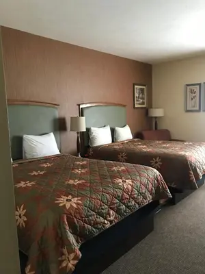 a hotel room with two beds and two lamps at Randolph Inn and Suites in Winchester