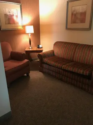 a living room with a couch and a chair at Randolph Inn and Suites in Winchester