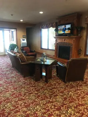 a living room with couches and a fireplace at Randolph Inn and Suites in Winchester