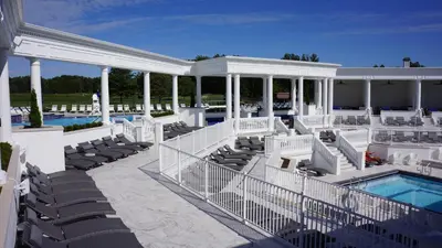 a view of the pool and patio of a mansion at The Grand Resort in Howland Corners