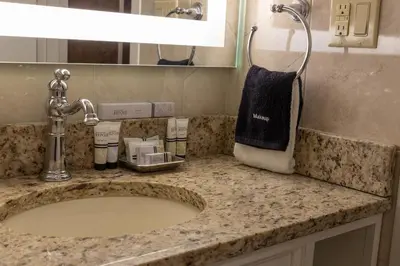 a bathroom counter with a sink and a towel at The Grand Resort in Howland Corners