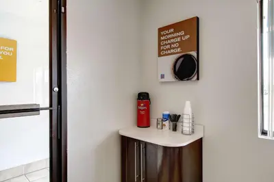 a small table in a room with a refrigerator at Motel 6-Amherst, OH - Cleveland West - Lorain in Amherst