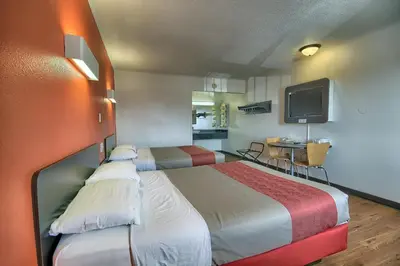 a hotel room with two beds and a television at Motel 6-Lima, OH in Lima