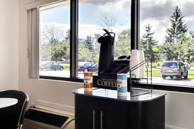a counter with a coffee box on it in front of a window at Motel 6-Middleburg Heights, OH - Cleveland in Middleburg Heights