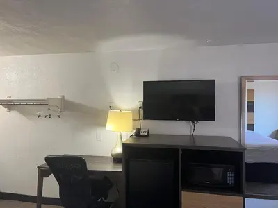 a room with a desk with a television and a bed at Motel 6 Cross Lanes, WV Goff Mountain Rd in Cross Lanes