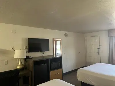 a hotel room with a bed and a television at Motel 6 Cross Lanes, WV Goff Mountain Rd in Cross Lanes
