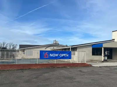 a now open sign in front of a building at Motel 6 Cross Lanes, WV Goff Mountain Rd in Cross Lanes