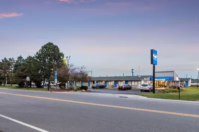 an empty street with a building and a parking lot at Rodeway Inn Near Hall of Fame in Canton