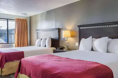 a hotel room with two beds and a window at Rodeway Inn Near Hall of Fame in Canton