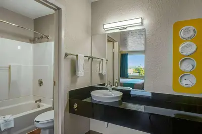 a bathroom with a sink and a toilet and a mirror at Motel 6 Lexington I-75 Hamburg in Lexington