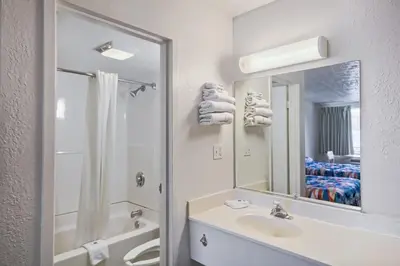 a white bathroom with a sink and a mirror at Motel 6 Lexington I-75 Hamburg in Lexington