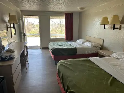 a hotel room with two beds and a television at Rodeway Inn Washington PA in Washington