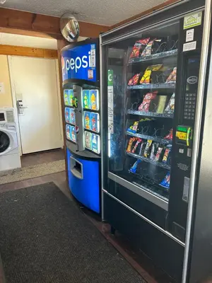 a soda machine in a grocery store with its door open at Rodeway Inn Washington PA in Washington