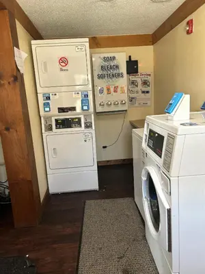 a laundry room with a washing machine and a washer at Rodeway Inn Washington PA in Washington