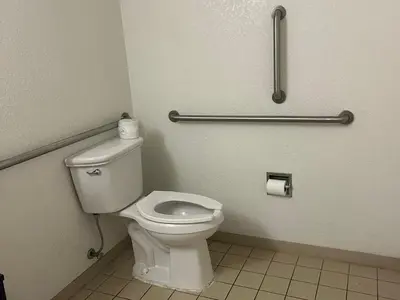 a bathroom with a white toilet in a stall at Rodeway Inn Washington PA in Washington