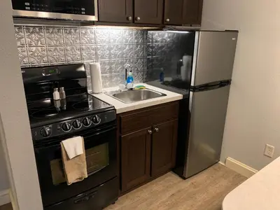 a kitchen with a stove and a sink and a refrigerator at McCoy's Inn in Ripley