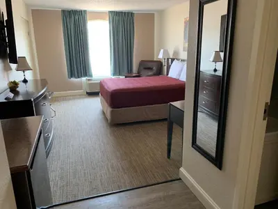 a hotel room with a bed and a mirror at McCoy's Inn in Ripley