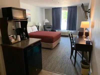 a hotel room with a bed and a desk at McCoy's Inn in Ripley