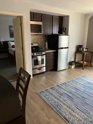 a kitchen with a refrigerator and a table in a room at McCoy's Inn in Ripley
