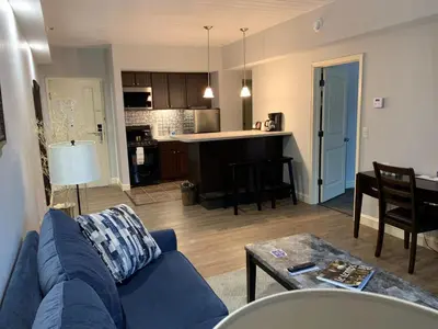 a living room with a blue couch and a kitchen at McCoy's Inn in Ripley