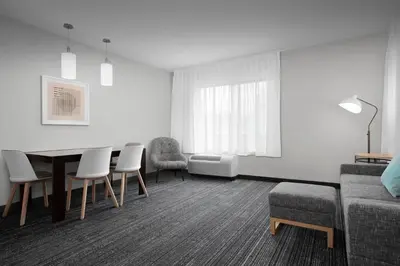 a living room with a table and chairs and a couch at TownePlace Suites Bridgeport Clarksburg in Bridgeport