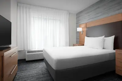 a hotel room with a bed and a television at TownePlace Suites Bridgeport Clarksburg in Bridgeport