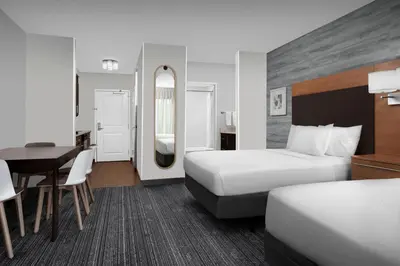 a hotel room with two beds and a desk at TownePlace Suites Bridgeport Clarksburg in Bridgeport