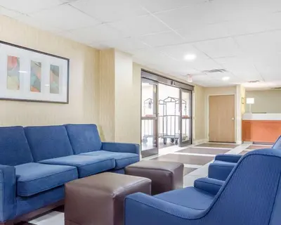 a waiting room with blue couches in a room at Comfort Inn Winchester in Winchester
