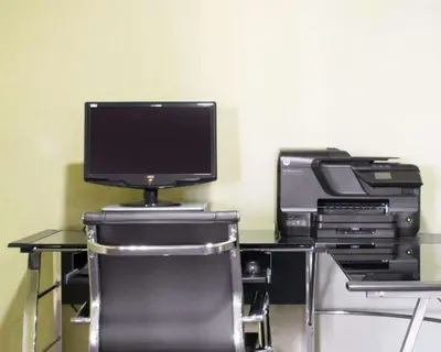 a computer desk with a monitor and other electronics at Comfort Inn Winchester in Winchester