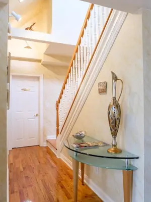 a glass table in a hallway with a staircase at Gaslight Bed & Breakfast in Cincinnati